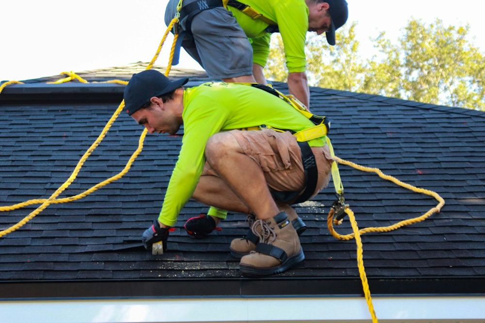 Roofers installing shingles