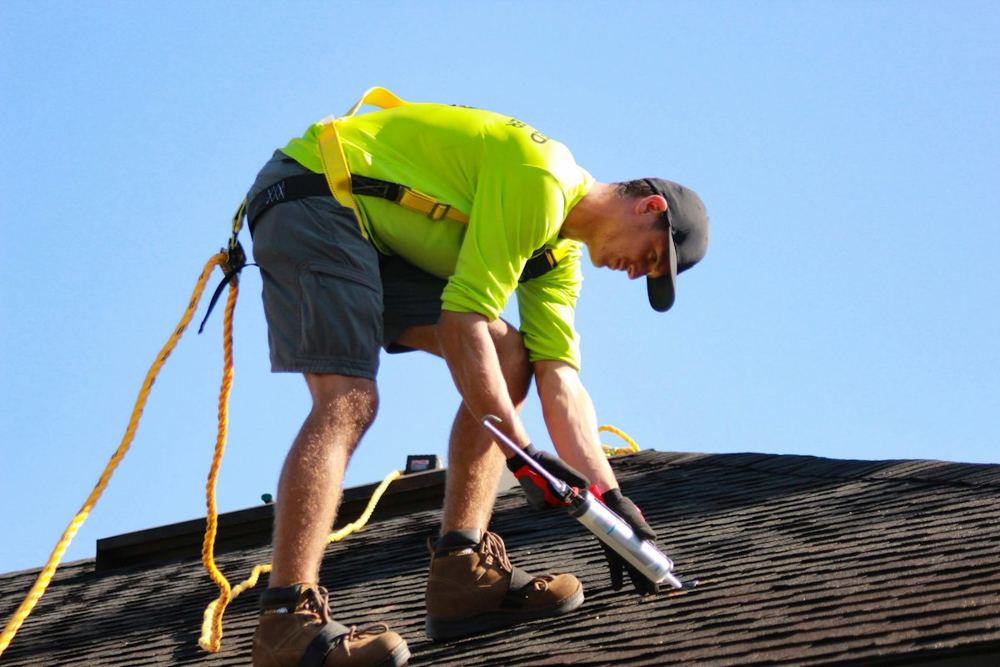 Roofer working on a shingle roof